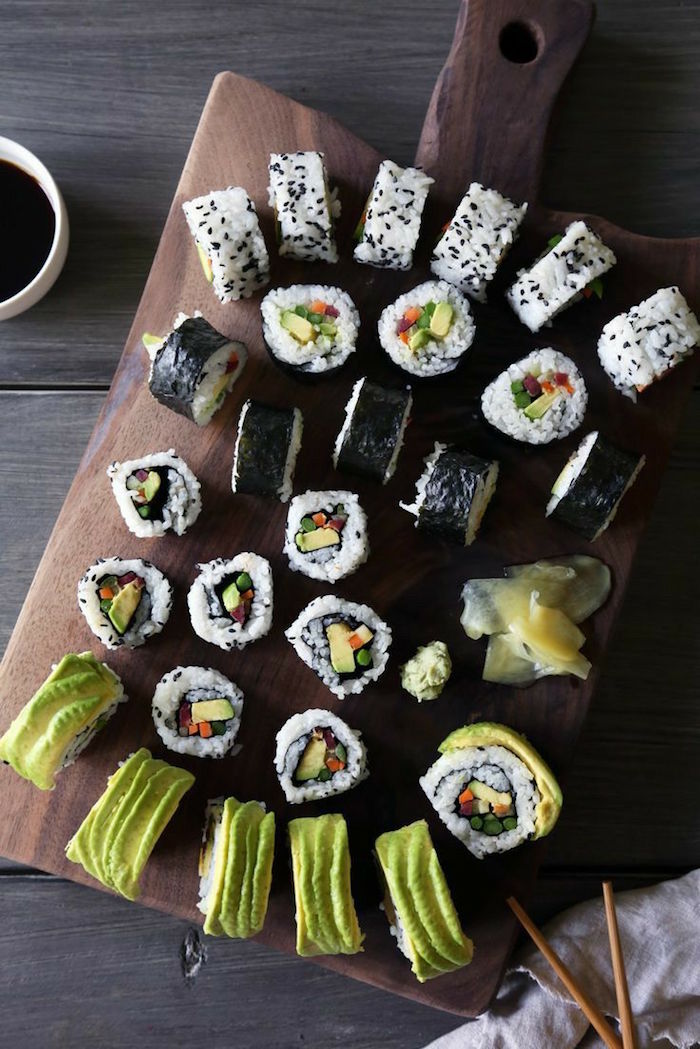 vegetable sushi rolls arranged on wooden cutting board how to make sushi at home rolled in different ways