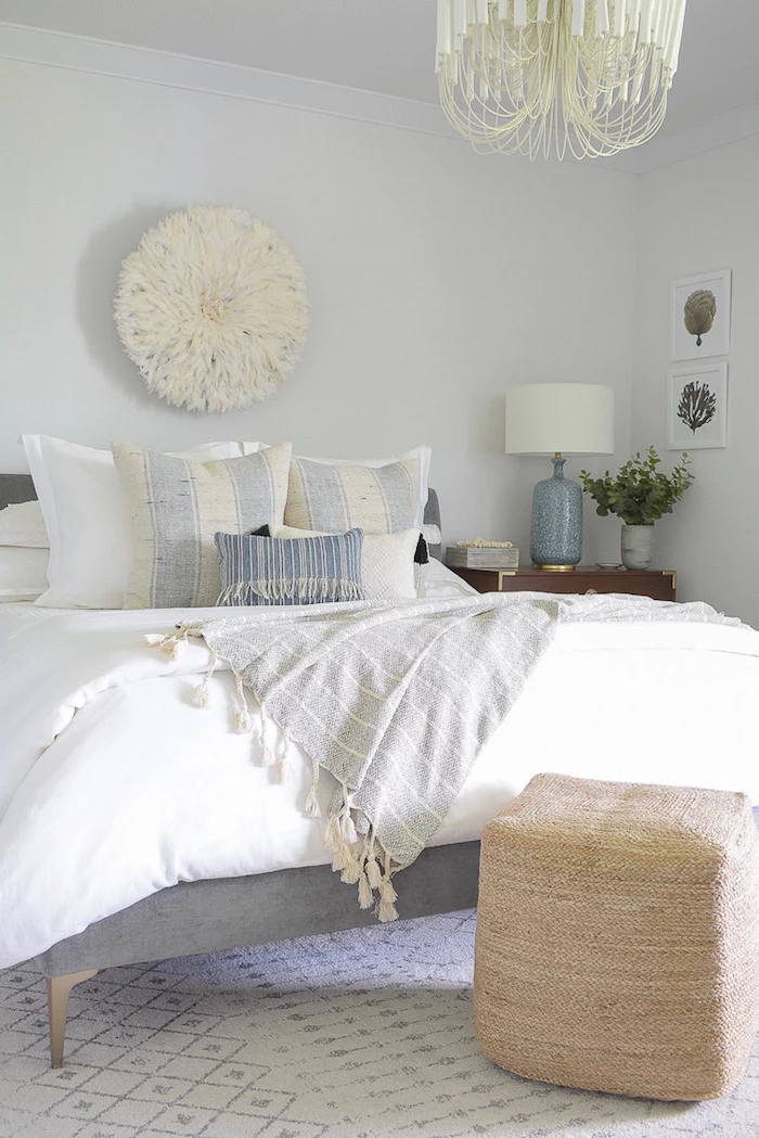 beach themed decor bed with gray bed frame throw pillows in gray and blue placed on white carpet white walls