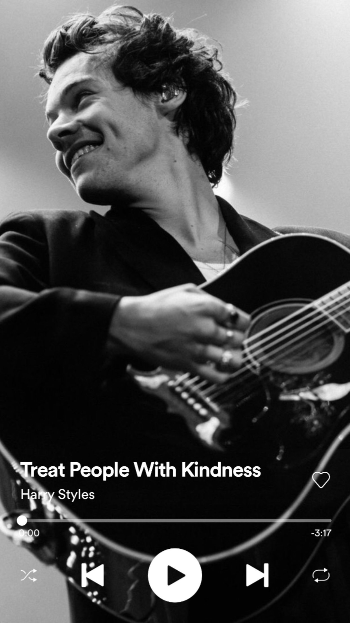 black and white photo of harry styles on stage playing the guitar harry styles lockscreen treat people with kindness playing