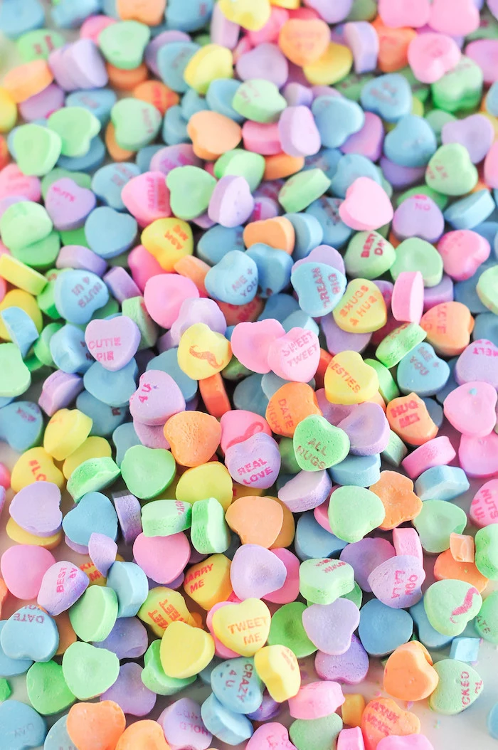 candy conversation hearts in different colors with different sayings valentines day wallpaper close up photo