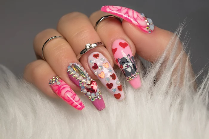 cat hearts roses drawn on long coffin nails with pink nail polish valentines day nails 2021 lots of decorations with rhinestones