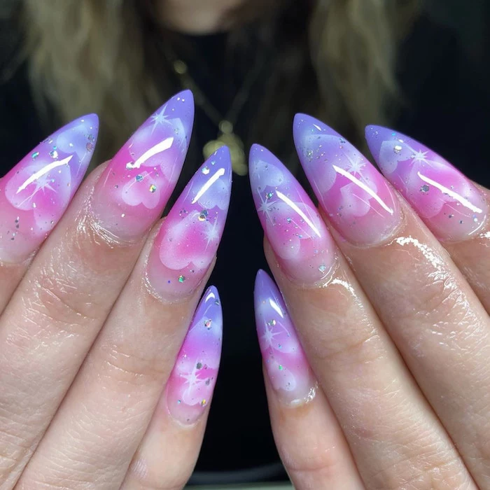 cloud like ombre nails in purple and pink with hearts drawn on them valentine nail designs long stiletto nails