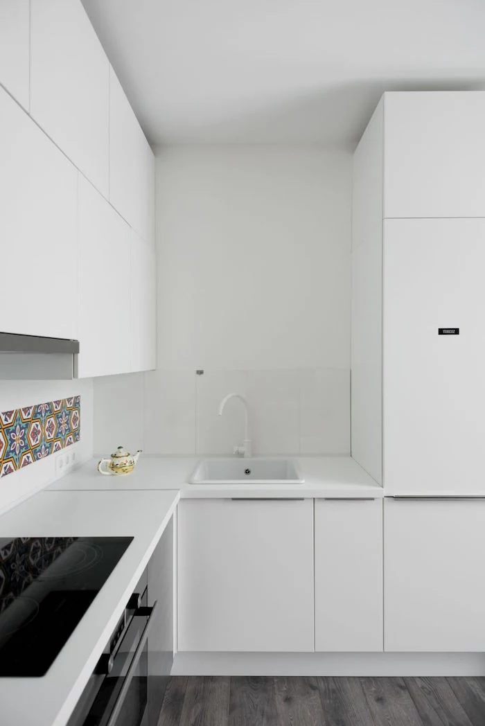 colorful tiles on white backsplash small kitchen design ideas white kitchen cabinets white countertops dark wooden floor
