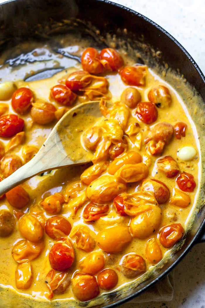 cooking cherry tomatoes in cheesy sauce how to cook gnocchi black casserole dish wooden spoon