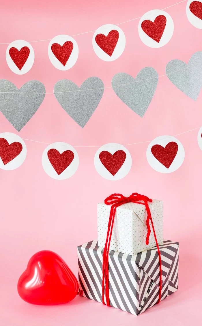 cute valentines day wallpaper pink background red and silver hearts garland red heart shaped balloon two presents wrapped in black white wrapping paper