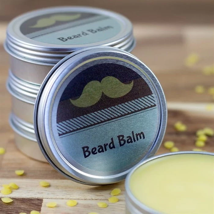 diy beard balm placed inside small tin jars what to get a guy for valentines day placed on wooden surface