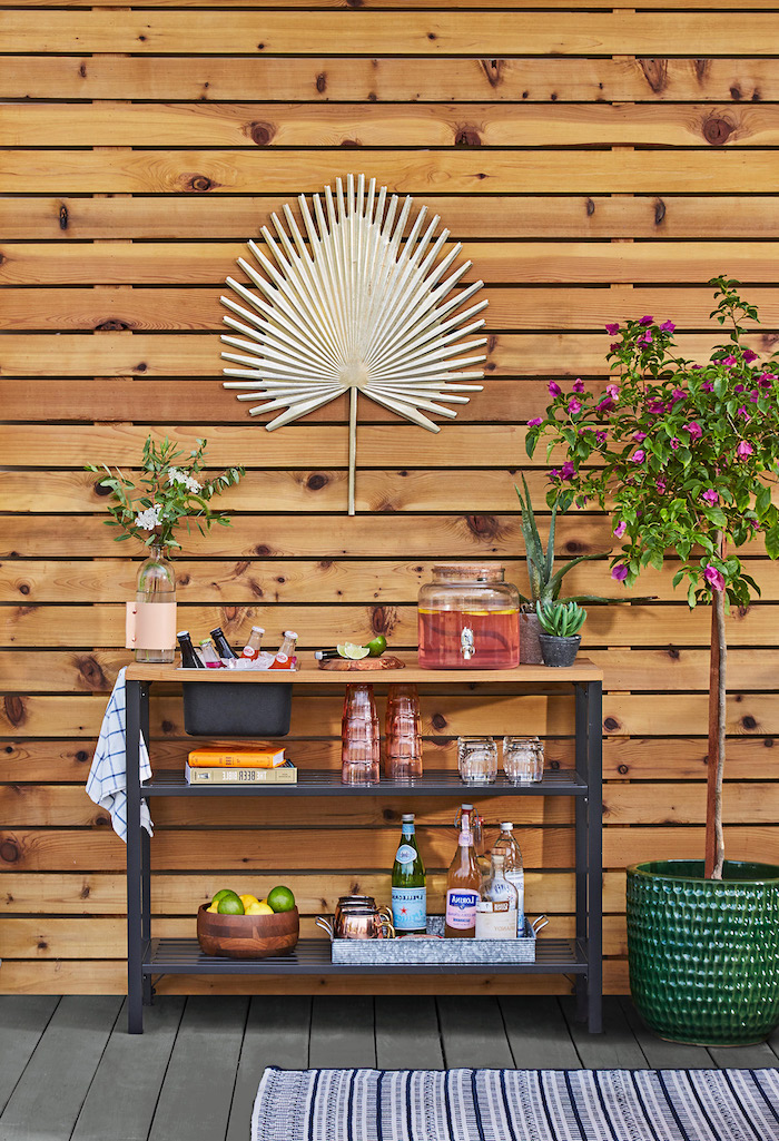 diy storage space black metal cart with wooden countertop lots of different drinks and glasses arranged on it