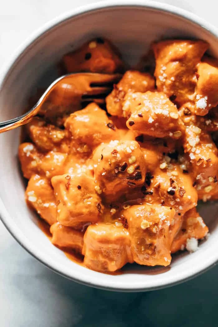 easy gnocchi recipe cooked cauliflower gnocchi with sauce garnished with chilli pepper flakes