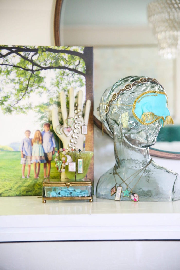 epoxy resin jewelry glass statue next to photo of three children jewelry box with lots of necklaces