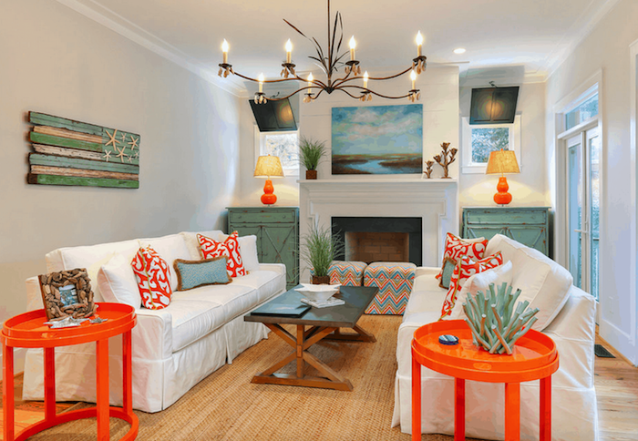 fireplace with two vintage cabinets on both sides beach bathroom decor white sofas with orange throw pillows orange side tables