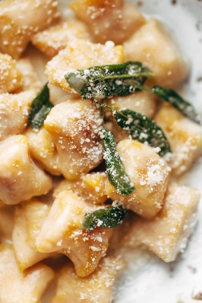 gnocchi made from pumpkin easy gnocchi recipe cooked with cheesy sauce garnished with fresh mint leaves grated parmesan cheese