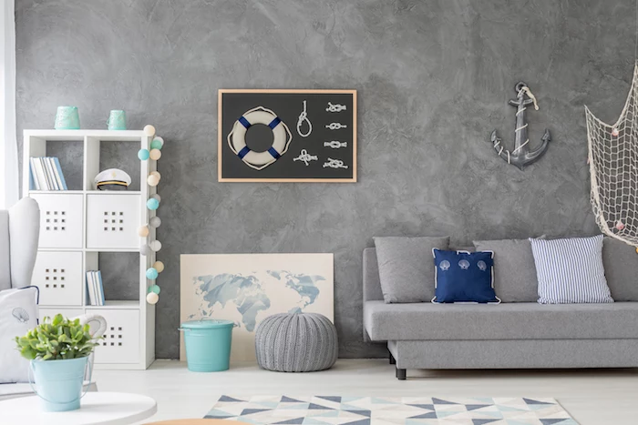 gray accent wall gray sofa with blue and white throw pillows coastal decorating ideas white bookshelf