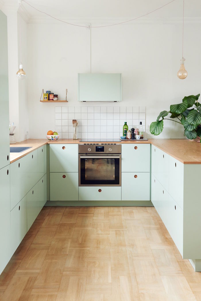 green kitchen cabinets small kitchen remodel white tiled backsplash wooden countertop and floor