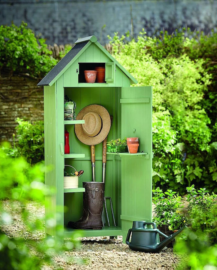 green wooden shed for gardening tools diy storage space small wooden shelves installed inside and on the door