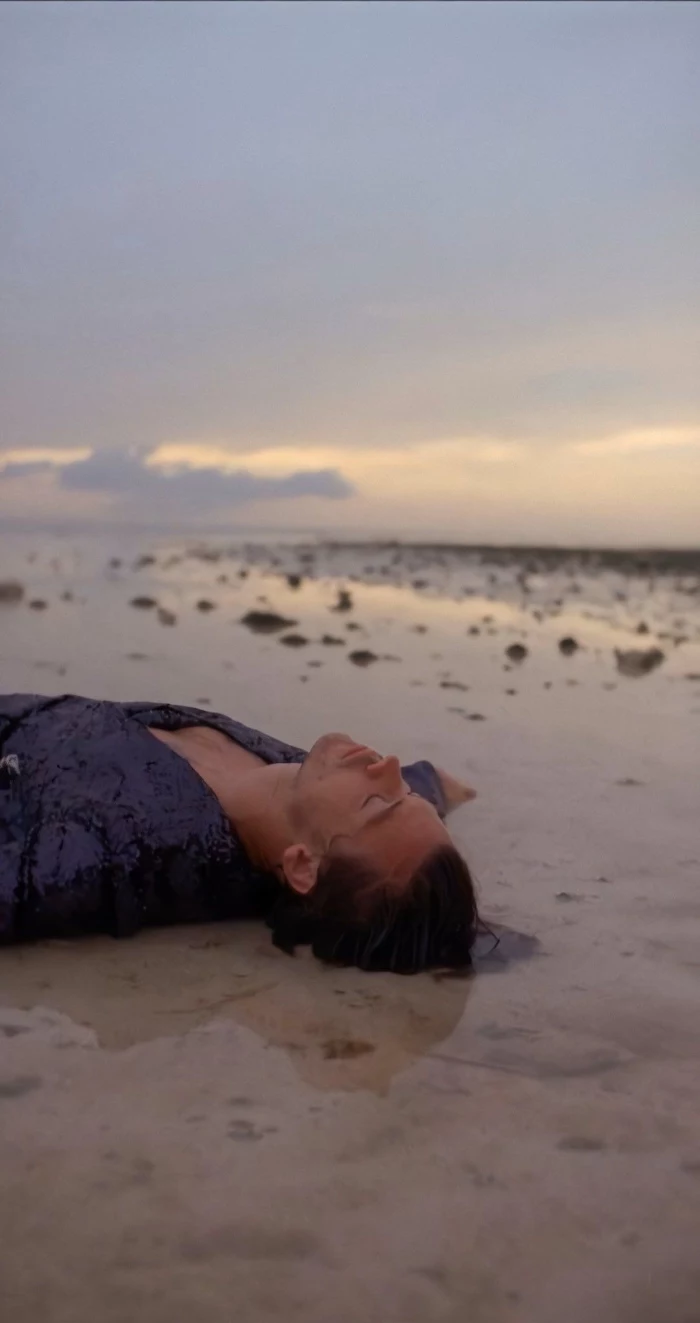 harry lying on the beach harry styles pictures wearing black sequinned shirt with closed eyes
