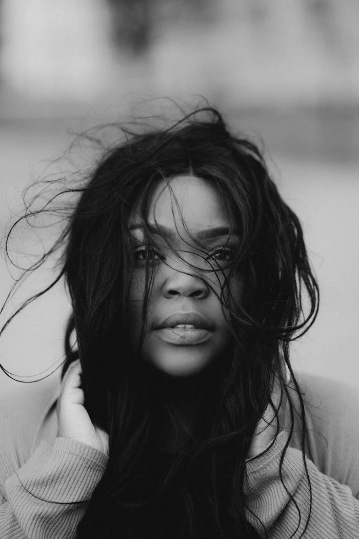keep your hair healthy black and white photo of woman with long black hair wind blowing her hair