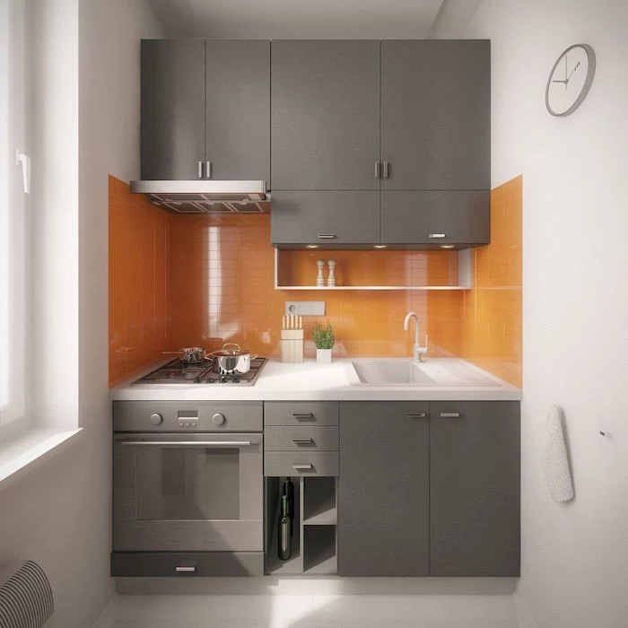 light gray kitchen cabinets orange tiled backsplash small kitchen remodel white walls and floor