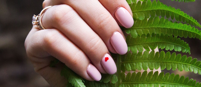 light pink nail polish on short squoval nails valentines nail designs 2021 small red heart on ring finger
