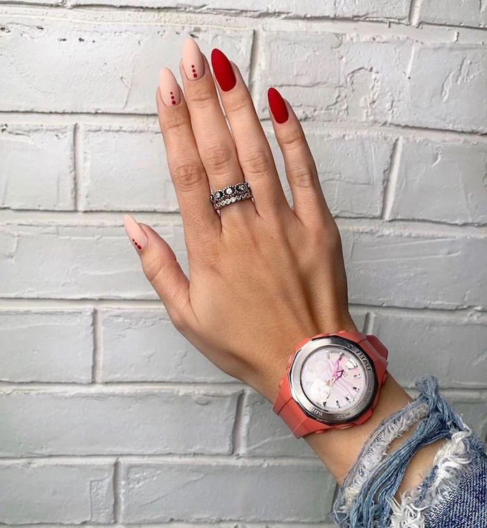 long almond nails covered with red and beige matte nail polish cute nail designs orange watch silver rings