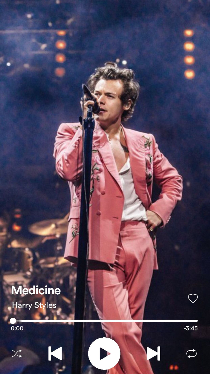 medicine playing over photo of harry styles on stage harry styles lockscreen wearing pink suit white shirt