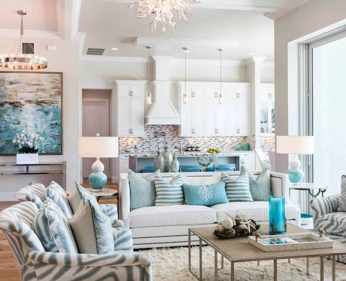 open plan living room and kitchen beach house decor white sofas and armchairs with blue and gray throw pillows