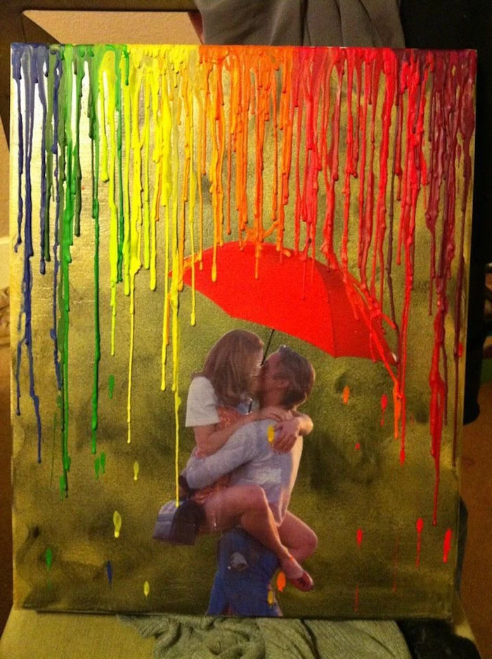 photo of couple kissing umbrella above them on gold background valentine gift for husband crayons melted for rain in the colors of the rainbow
