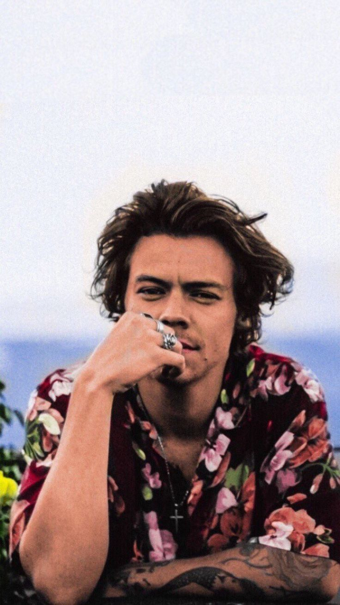 photo of harry wearing burgundy red floral shirt harry styles iphone wallpaper lots of rings on his fingers