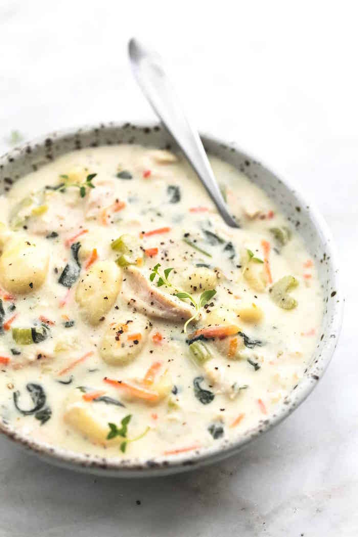recipes using gnocchi small white bowl with spoon on the side gnocchi soup with chicken and fresh herbs