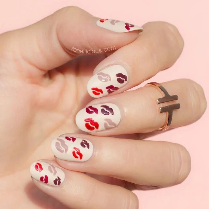 red gray and purple lips drawn on white nail polish valentines nails medium length almond nails