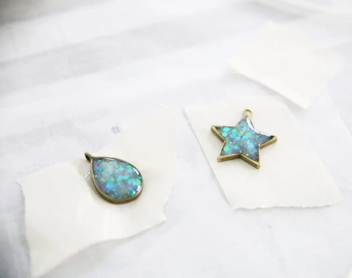 two bronze pendant necklaces filled with glitter epoxy resin jewelry teardrop and star shapes