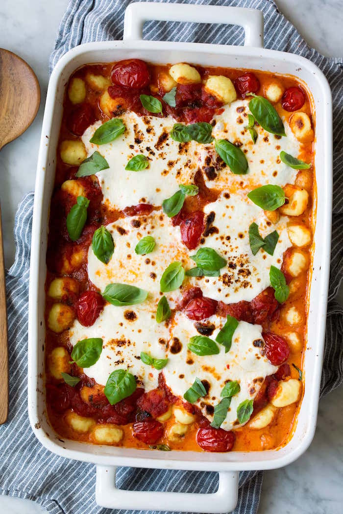 white casserole with baked gnocchi with tomatoes burrata cheese and fresh basil leaves how to make gnocchi
