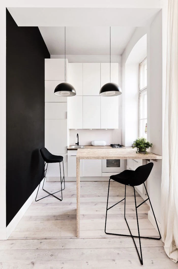 white kitchen cabinet ideas black wall wooden floor small wooden table two black metal bar stools