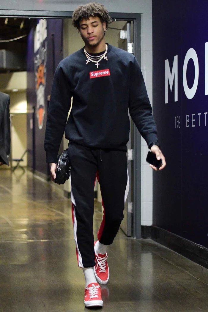 kelly oubre jr wearing black supreme sweatshirt black pants red sneakers streetwear women