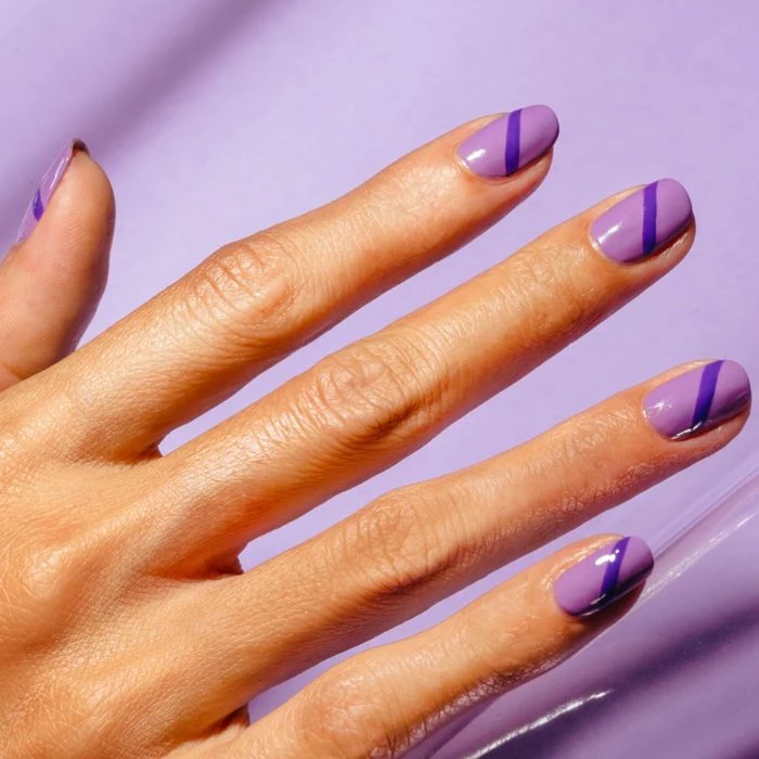almond nail shape pretty nail designs purple nail polish with darker purple line going through the nail