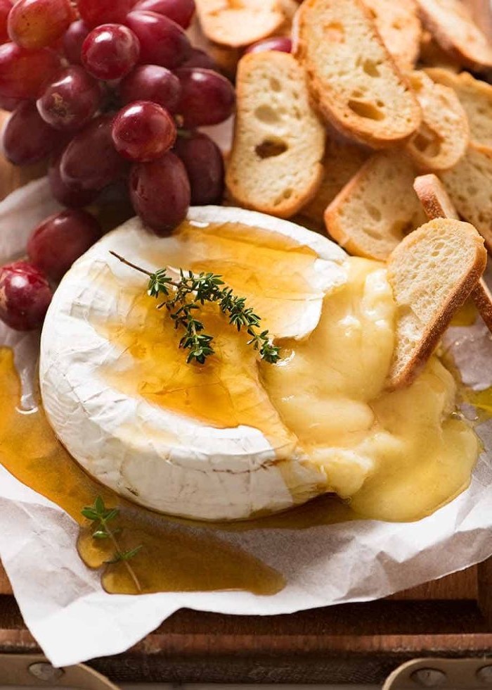 baked brie with honey and thyme charcuterie board bread and grapes on the side