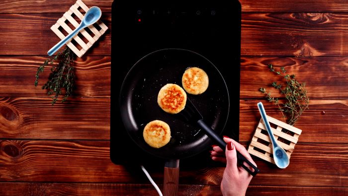 birthday party food ideas stuffed potato bites being fried on each side in black saucepan