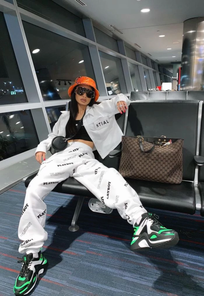 black and green sneakers black top white pants white crop top orange beanie mens hip hop clothing airport fashion