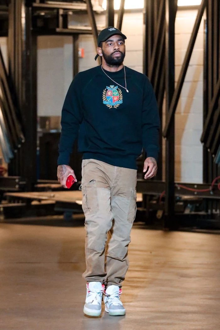 black sweater gray pants white and gray sneakers streetwear outfits worn by kyrie irving