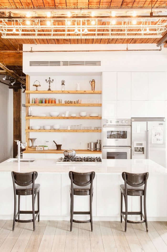 black wooden stools next to white kitchen island kitchen shelf ideas wooden with white backdrop