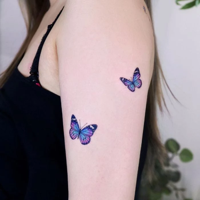 blue and purple watercolor two butterflies on the side of the arm butterfly tattoos on shoulder