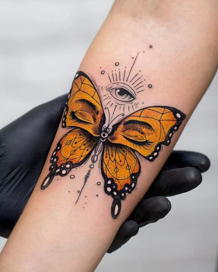 butterfly tattoo on arm orange butterfly with black outline set of eyes forearm tattoo