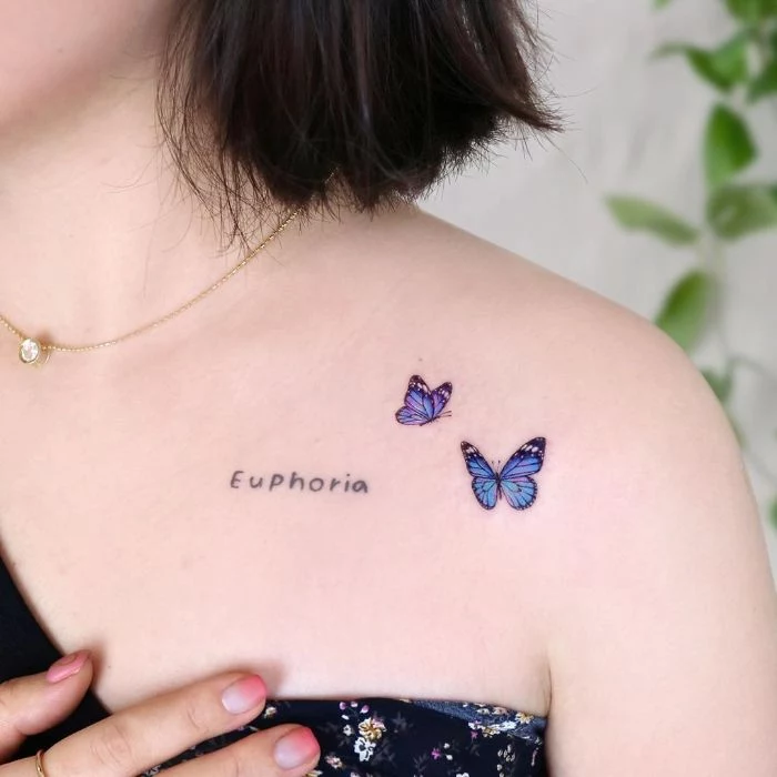 butterfly tattoo two blue butterflies in flight euphoria written next to them shoulder tattoo