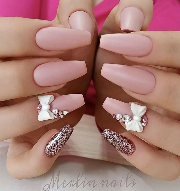 coffin nails with pink matte nail polish and pink glitter 2021 nail trends decorations with rhinestones and bows