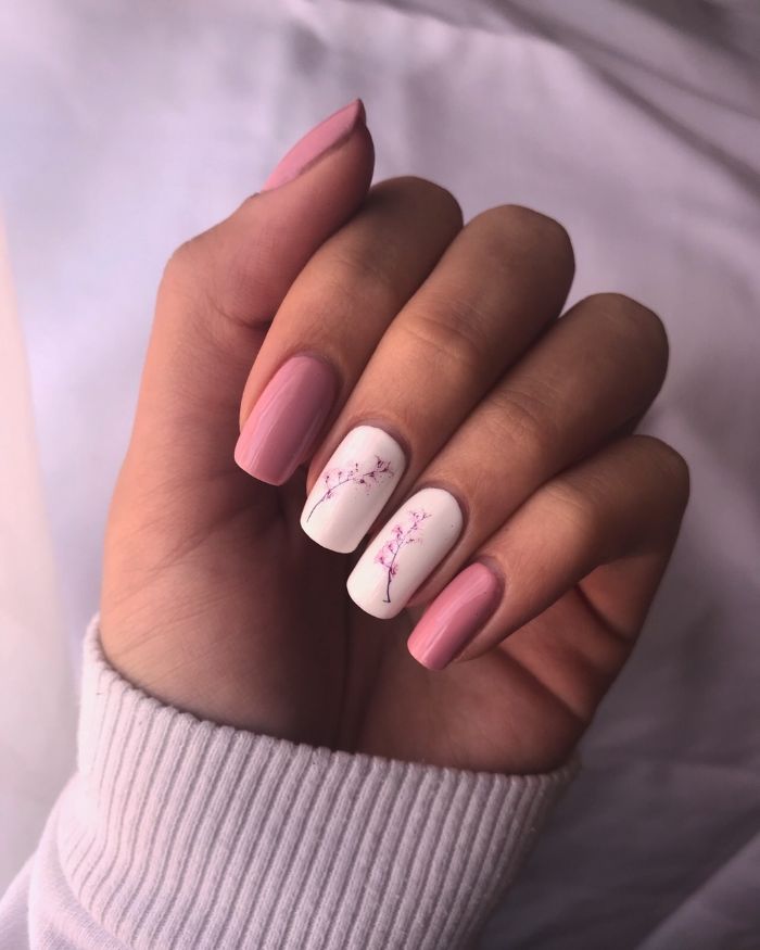 floral decorations and white nail polish on middle and ring fingers pretty nail designs pink nail polish on long square nails