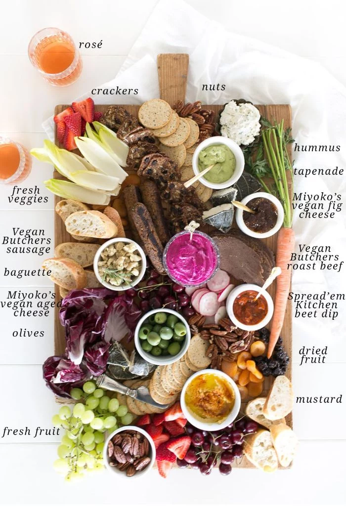 how to make a charcuterie board different types of cheese meat fruits veggies arranged on wooden board
