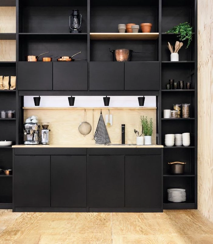 kitchen with black cabinets accents hanging kitchen shelves wooden backdrop and floor