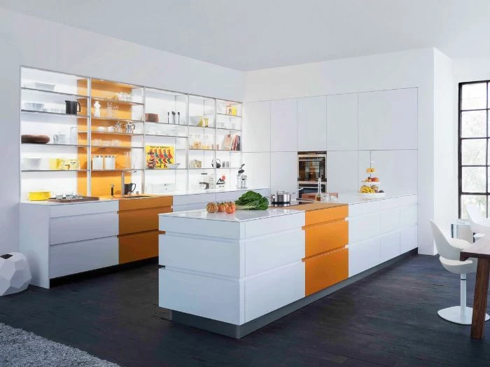 large kitchen with white cabinets and kitchen island with orange accents floating kitchen shelves