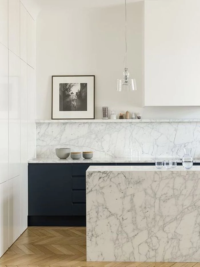 marble kitchen island and backdrop dark blue bottom cabinets hanging kitchen shelves minimalist kitchen