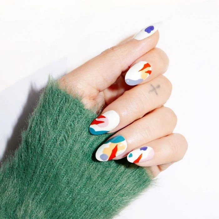 medium length almond nails with white base nail designs 2021 abstract brush strokes on them in blue red orange