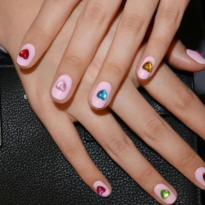 nail designs for short nails in almond shape pink nail polish base heart rhinestones different color on each finger
